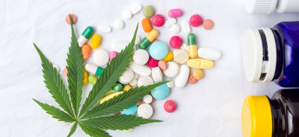 cannabis leaf with assorted prescription pills