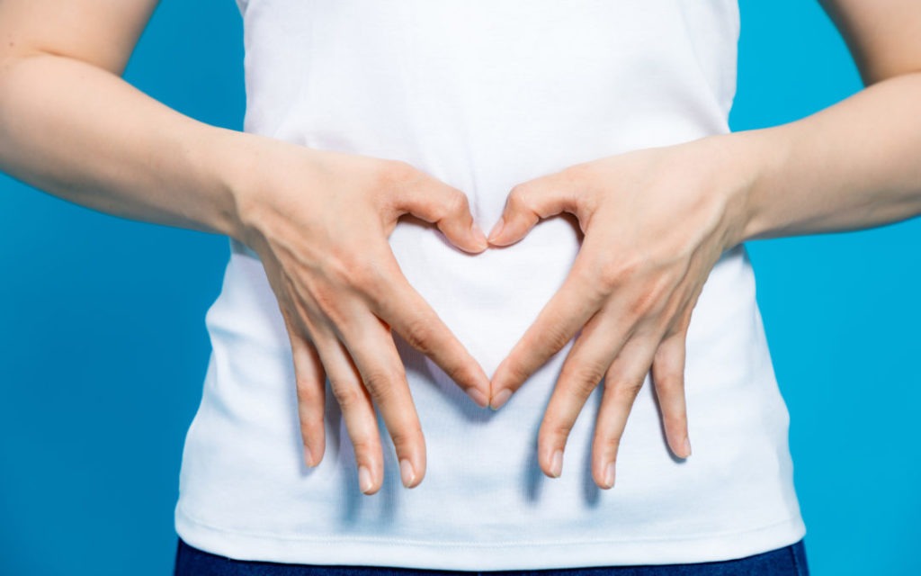 hands making heart shape on stomach