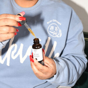 Woman using a TONIC cbd tincture the og cbd and ashwagandha